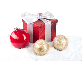 christmas red gift with festive decorations on snow background