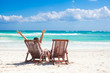 © travnikovstudio - Young father with little daughter in beach chairs raised their