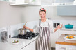 © lightwavemedia - Laughing pretty woman with apron cooking