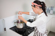 © lightwavemedia - Focused gorgeous cook putting salt on vegetables