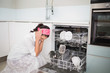 © lightwavemedia - Worried charming woman sitting next to dish washer