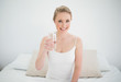 © lightwavemedia - Natural smiling blonde holding glass of water