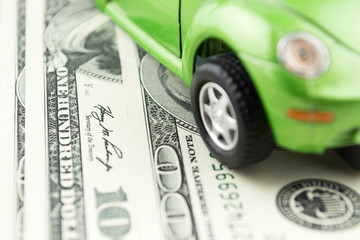 Toy car and money over white  Rent, buy or insurance car concept