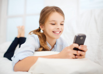 Canvas Print - girl with smartphone at home