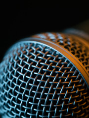 Wall Mural - Vocal microphone macro over dark background