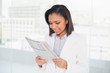 © lightwavemedia - Attentive young dark haired businesswoman reading a document