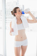 © lightwavemedia - Peaceful fit brown haired model in sportswear drinking water