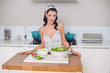 © lightwavemedia - Smiling cute brunette cooking