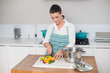 © lightwavemedia - Focused pretty woman chopping vegetables