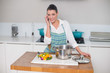 © lightwavemedia - Smiling gorgeous woman wearing apron having a call