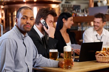 Poster - Young man drinking beer in pub