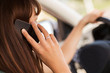 © Syda Productions - woman using phone while driving the car