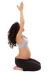 A pregnant woman stays fit with yoga.
