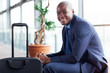 © michaeljung - african american businessman waiting in airport