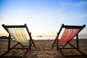 Wall Mural - Beach chairs on sea coast.