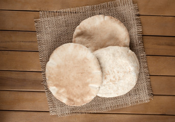 pitta bread (Lebanese Bread), over old burlap background