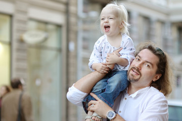 Wall Mural - Young father holding his little girl