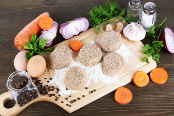 Poster - Meat patties on board on wooden table