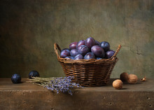 Still Life With Black Plums In A Basket On The Table
