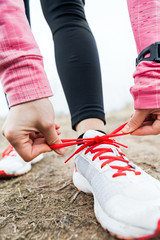 Wall Mural - Woman runner tying sport shoes