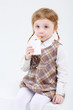© Pavel Losevsky - Little cute girl sits and drinks sweet juice on white background