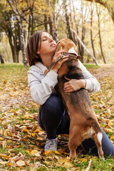 Wall Mural - Woman playing with her beagle pet