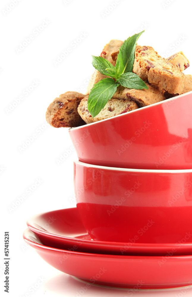 Tasty cookies in cups isolated on white