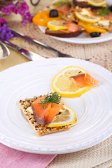 Sticker - Salmon sandwiches on plate  on wooden table close-up