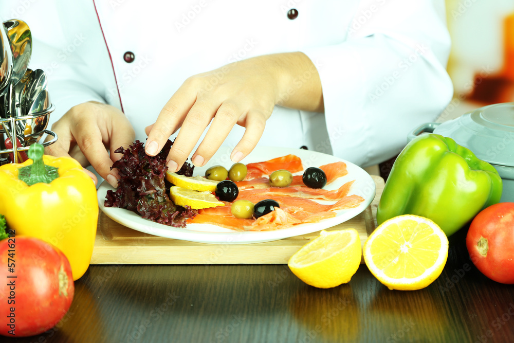 Cook hands decorating dish