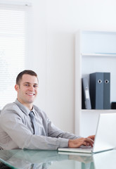 Wall Mural - Happy businessman using his laptop