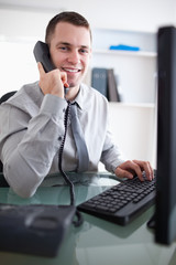 Wall Mural - Smiling businessman having a dialogue on the phone