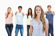 © WavebreakMediaMicro - Close-up of woman smiling with people approving behind her