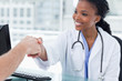 © WavebreakMediaMicro - Smiling female doctor shaking a hand