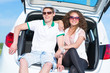 © adam121 - young couple sitting in the open trunk