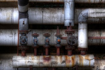 Wall Mural - Old pipes with valves in an Lost Place