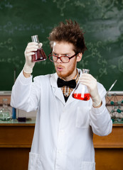 Wall Mural - Mad professor wonders at the flasks with colored liquid