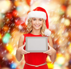 Canvas Print - woman in santa helper hat with tablet pc