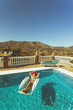 © Image Supply Co - Girl lounging in pool on vacation