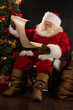 © Milles Studio - Portrait of happy Santa Claus reading Christmas letter or wish l