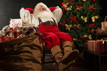 Santa Claus Keeping His Hands Behind Head While Relaxing At Home