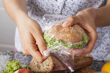 Wall Mural - Mother foiling a sandwich