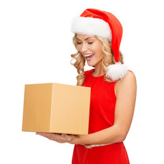 smiling woman in santa helper hat with gift box