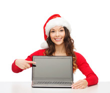 Woman In Santa Helper Hat With Laptop Computer