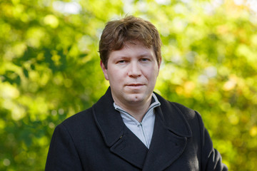 Portrait of young man in beautiful autumn park.