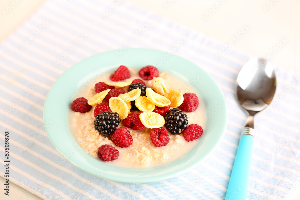 Oatmeal in bowl with berries isolated on white