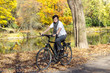 Woman on bicycle in autumn park