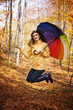 © gpointstudio - Young woman jumping during the rainy day at autumn