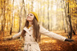 © gpointstudio - Young woman enjoying nature at autumn