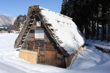 Thatched Roof House Covered In Snow
