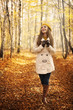 © gpointstudio - Smiling woman walking in park at autumn season
